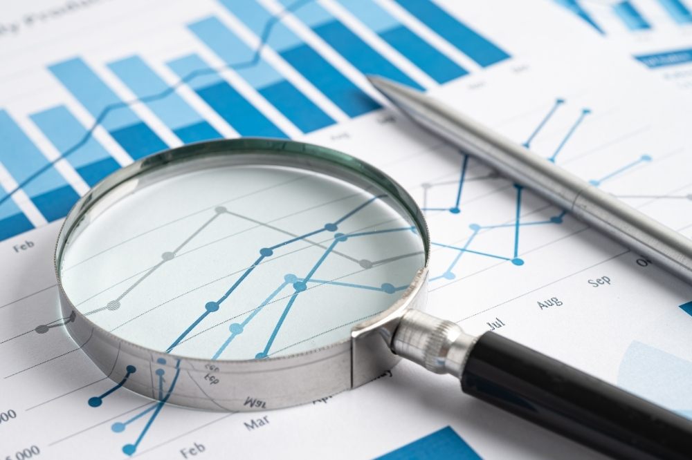 A magnifying glass over charts